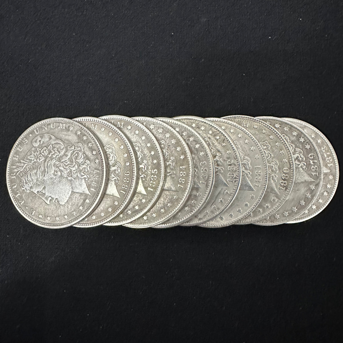 obverses of 10 morgan dollar replica coins from 1878 to 1887