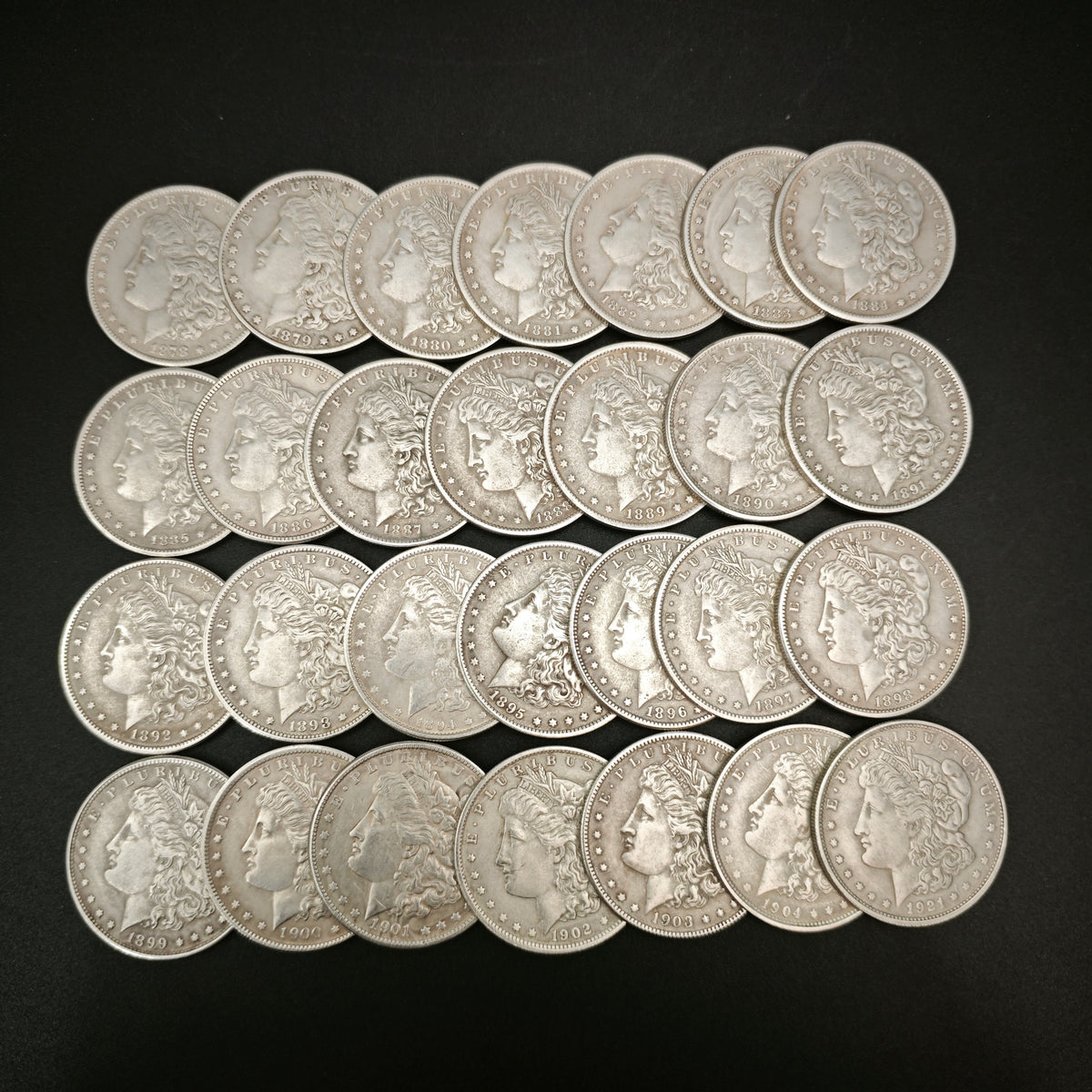 obverses of 28 morgan dollar replica coins (1878-1921)